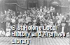 Black and white photograph showing individuals from Windle Sunday School and Day School, St.Helens, taking part in V. E. Day celebrations in Queen Street, St.Helens, c.1945